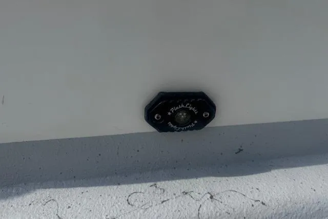 Slide: The Image of 2007 Haynie 23 Bigfoot boat detail with a black flush light on white surface. - 19