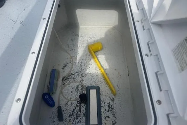 Slide: The Image of Storage compartment of a 2007 Haynie 23 Bigfoot boat with tools and accessories. - 21