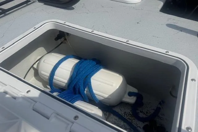 Slide: The Image of Storage compartment on 2007 Haynie 23 Bigfoot boat with blue rope and fender. - 22