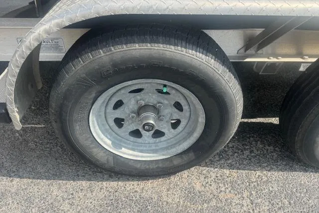 Slide: The Image of Trailer wheel of a 2007 Haynie 23 Bigfoot on asphalt surface. - 24