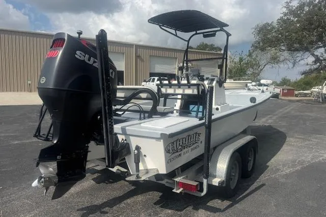 Slide: The Image of 2007 Haynie 23 Bigfoot boat with Suzuki engine on a trailer, parked outdoors. - 3