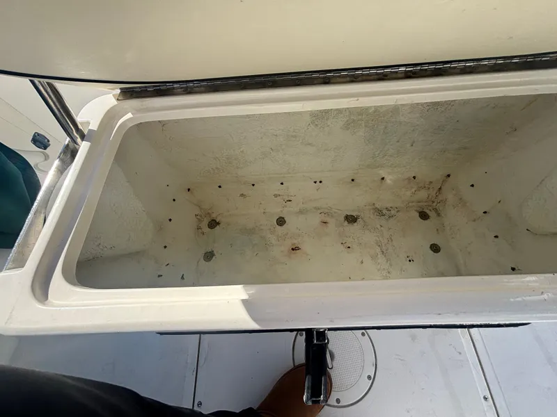 Slide: The Image of Open storage compartment on a 2000 Boston Whaler 180 Dauntless boat. - 17