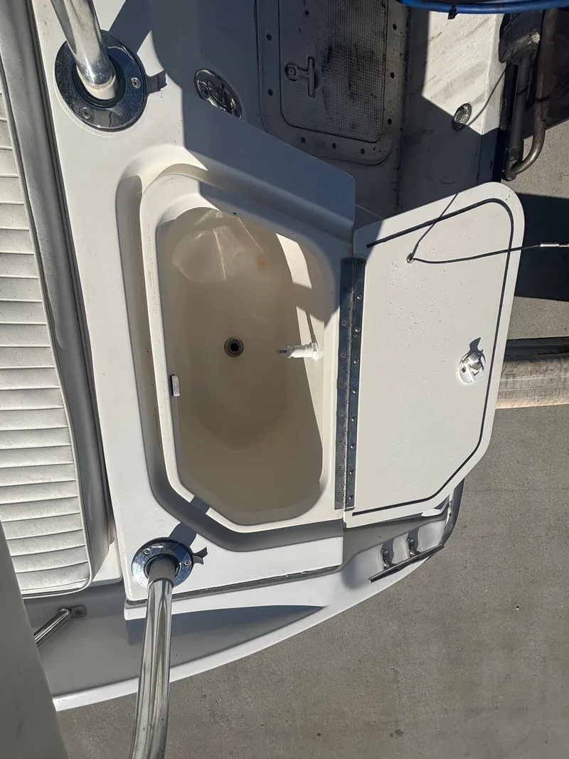 Slide: The Image of Boston Whaler 180 Dauntless 2000 with open storage compartment lid. - 22