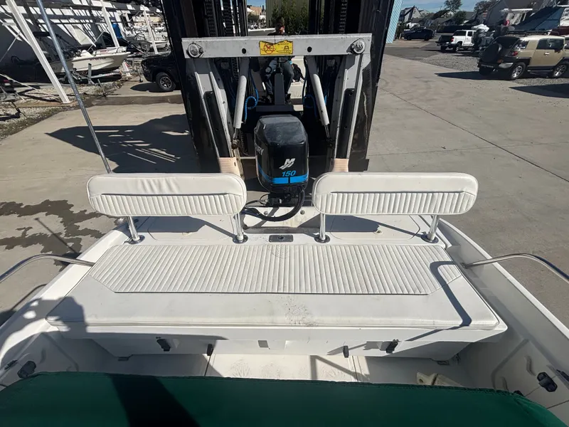 Slide: The Image of Boston Whaler 180 Dauntless 2000 with outboard motor on a boat lift. - 6