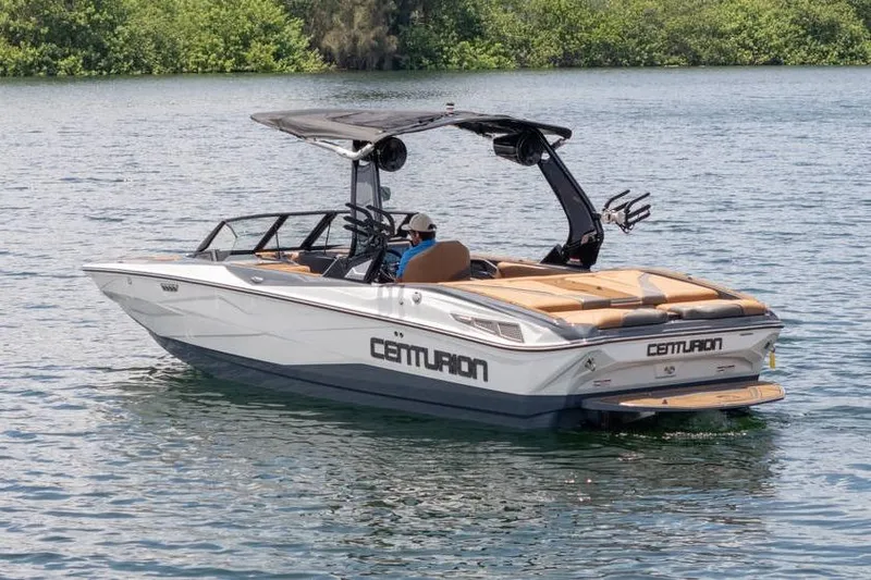 Slide: The Image of 2025 Centurion Nv233 boat on water, featuring sleek design and modern amenities. - 14
