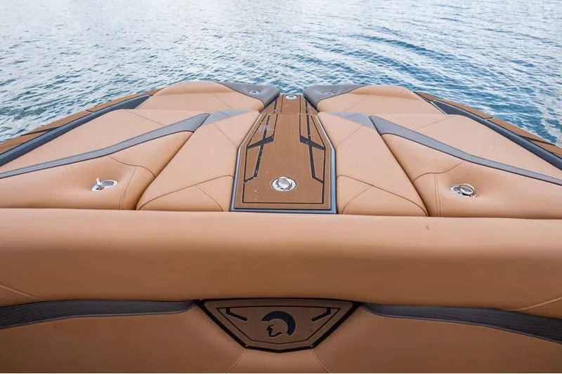 Slide: The Image of Luxury Centurion Nv233 boat deck, 2025 model, with tan upholstery and sleek design on water. - 25