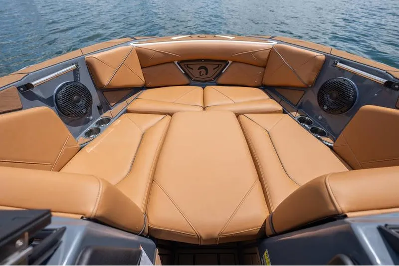 Slide: The Image of Luxurious seating area on 2025 Centurion Nv233 boat with tan upholstery and speakers. - 34