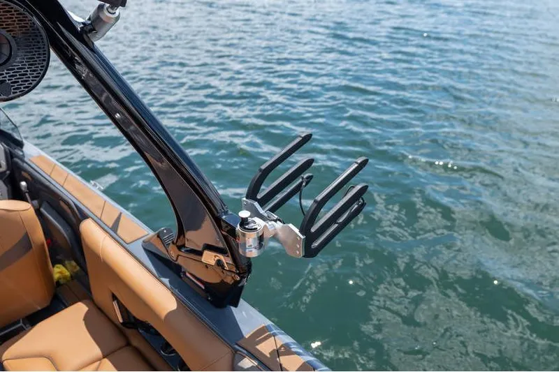 Slide: The Image of Centurion Nv233 2025 boat with wakeboard rack on calm water. - 39