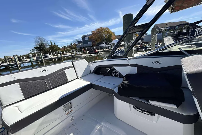 Slide: The Image of 2018 Monterey 278SS Super Sport boat interior with sleek seating at a marina. - 13