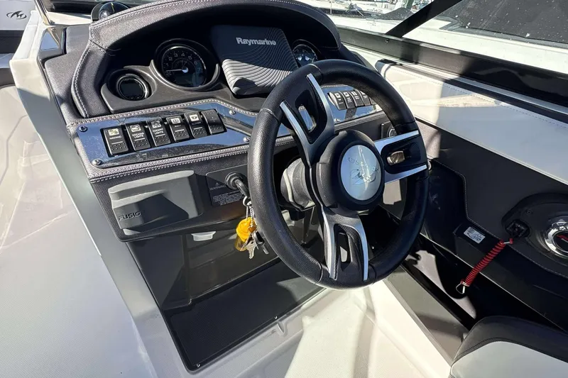 Slide: The Image of 2018 Monterey 278SS Super Sport boat dashboard with steering wheel and control panel. - 6