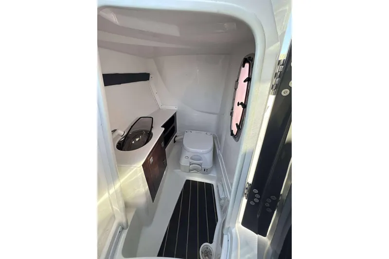 Slide: The Image of 2018 Monterey 278SS Super Sport boat interior with compact bathroom and sink. - 8
