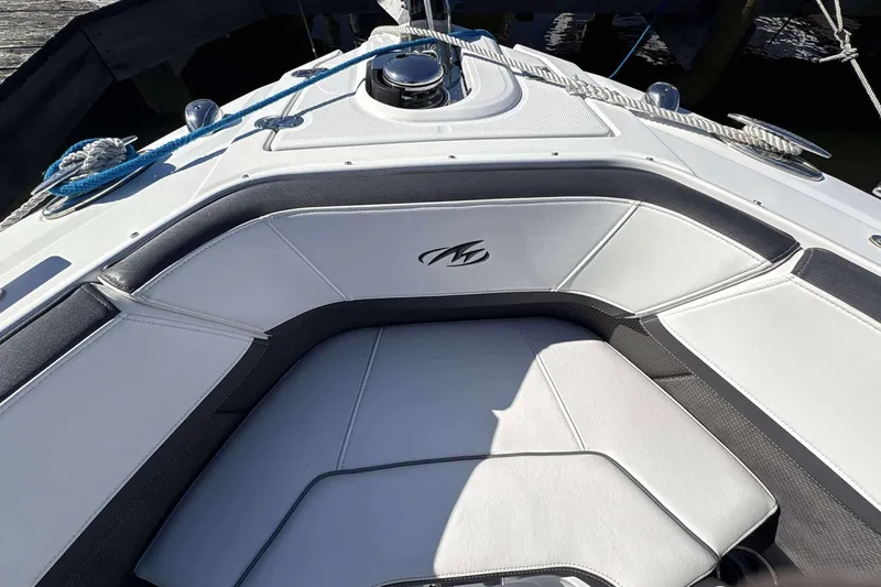 Slide: The Image of 2018 Monterey 278SS Super Sport boat interior with white cushioned seating and logo. - 9