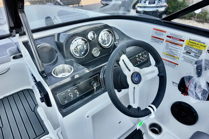 Slide: The Image of 2025 Bayliner VR4 Bowrider OB dashboard with steering wheel and instrument panel. - 12