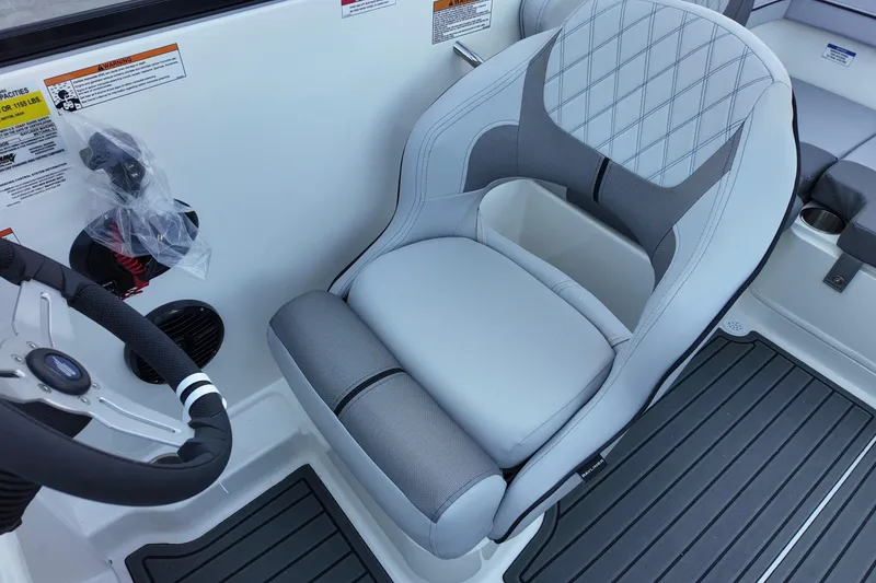 Slide: The Image of 2025 Bayliner VR4 Bowrider OB cockpit with modern steering and cushioned seating. - 7