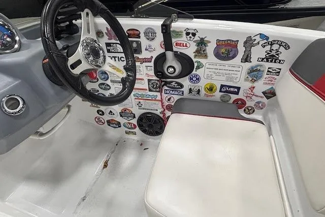 Slide: The Image of 2020 Tahoe T16 boat interior with white and gray seating, red accents, and storage compartment. - 25