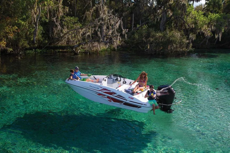 Slide: The Image of 2020 Tahoe T16 boat interior with white and gray seating, red accents, and dashboard controls. - 4