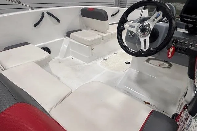 Slide: The Image of 2020 Tahoe T16 boat interior with cushioned seating and motor detail. - 45