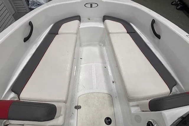 Slide: The Image of 2020 Tahoe T16 boat interior with red and gray seating, steering wheel, and Garmin equipment. - 5