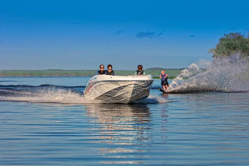 Slide: The Image of 2020 Tahoe T16 boat covered in black tarp on trailer in indoor storage. - 8