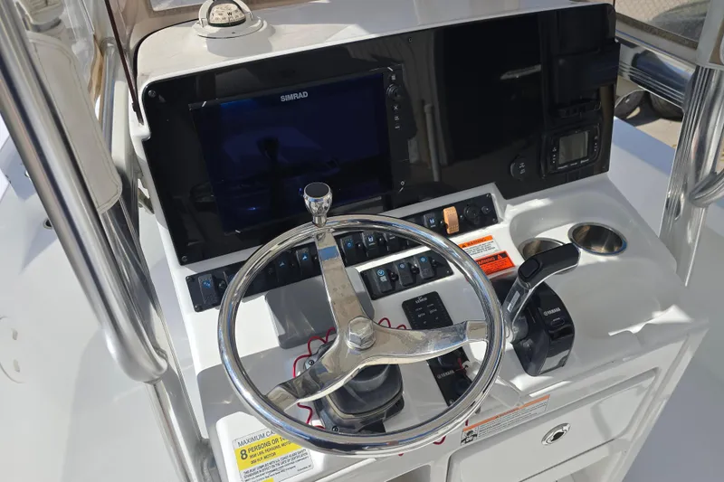 Slide: The Image of 2017 Sea Hunt BX 25 BR boat console with steering wheel and navigation controls. - 11