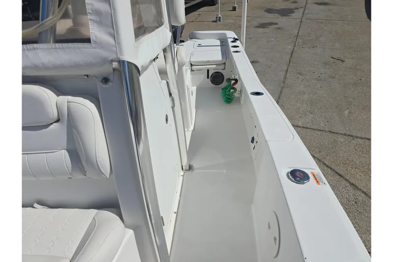 Slide: The Image of 2017 Sea Hunt BX 25 BR boat interior with white seating and deck. - 16