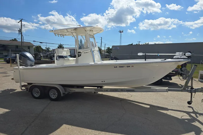 Slide: The Image of 2017 Sea Hunt BX 25 BR boat on trailer under clear blue sky. - 6