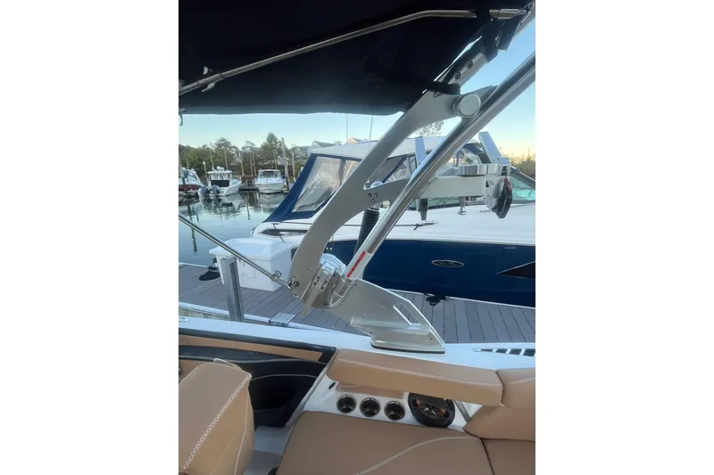 Slide: The Image of 2021 MasterCraft XT21 boat interior with view of marina and other boats. - 16