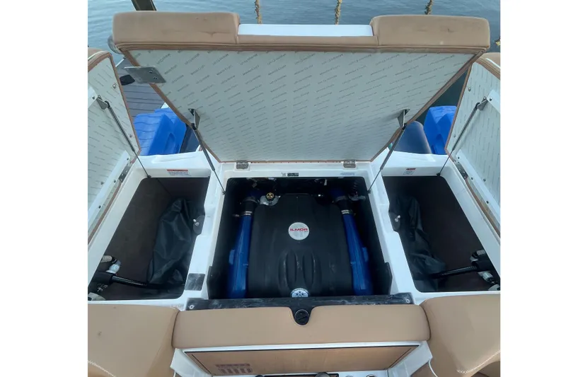 Slide: The Image of 2021 MasterCraft XT21 boat engine compartment with Ilmor engine, open storage hatches. - 29