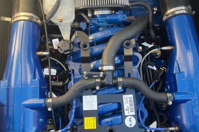 Slide: The Image of Engine of a 2021 MasterCraft XT21 boat, showcasing intricate components and blue detailing. - 31
