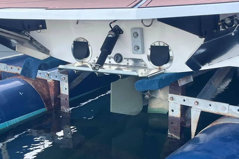 Slide: The Image of 2021 MasterCraft XT21 boat on lift, showing rear hull and propeller area. - 5