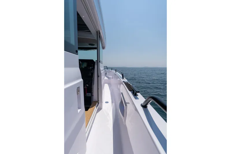Slide: The Image of 2026 Axopar 37 Aft Cabin boat, side view on open water. - 18