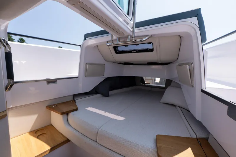 Slide: The Image of 2026 Axopar 37 Aft Cabin interior with modern design and comfortable bedding. - 47