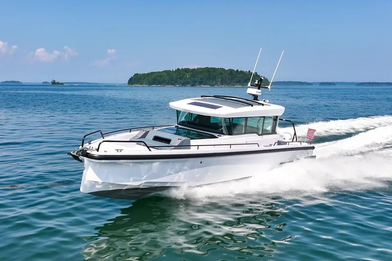 Slide: The Image of 2026 Axopar 37 Aft Cabin cruising on a sunny day in open waters. - 55
