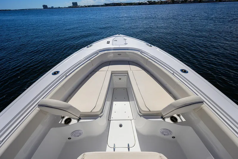 Slide: The Image of 2024 Sea Hunt Ultra 305 SE boat with spacious seating on calm water. - 14