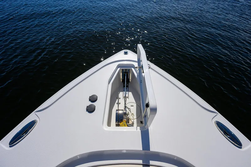 Slide: The Image of 2024 Sea Hunt Ultra 305 SE boat bow on calm water. - 16