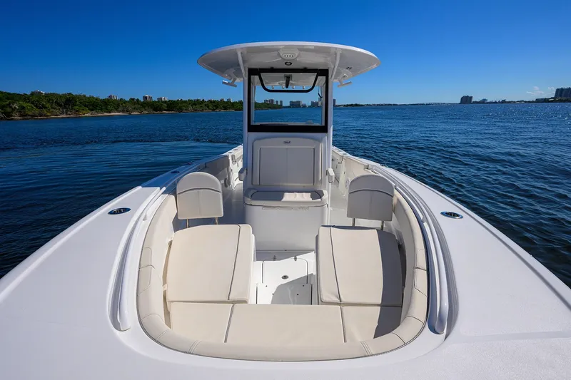Slide: The Image of 2024 Sea Hunt Ultra 305 SE boat on calm water, featuring spacious seating and sleek design. - 17
