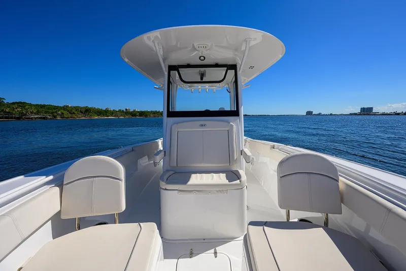 Slide: The Image of 2024 Sea Hunt Ultra 305 SE boat interior on calm blue water. - 18