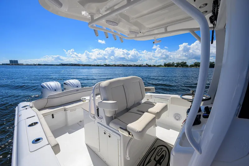 Slide: The Image of 2024 Sea Hunt Ultra 305 SE boat interior with dual engines on a sunny day. - 19