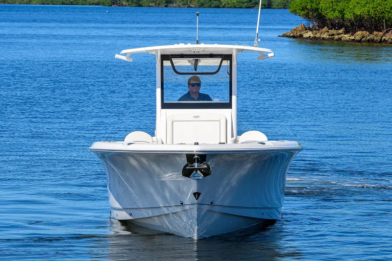 Slide: The Image of 2024 Sea Hunt Ultra 305 SE boat cruising on a calm blue waterway. - 2