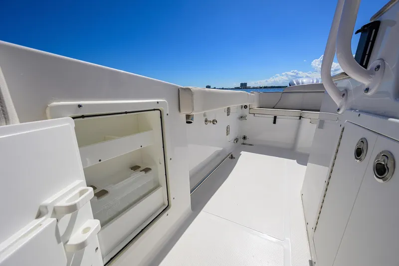 Slide: The Image of 2024 Sea Hunt Ultra 305 SE boat interior with storage compartments and seating. - 21