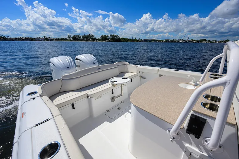 Slide: The Image of 2024 Sea Hunt Ultra 305 SE boat interior with dual engines on a sunny day. - 22