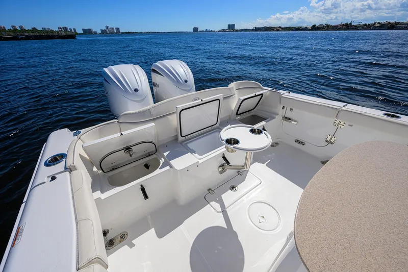 Slide: The Image of 2024 Sea Hunt Ultra 305 SE boat interior with dual engines on open water. - 23