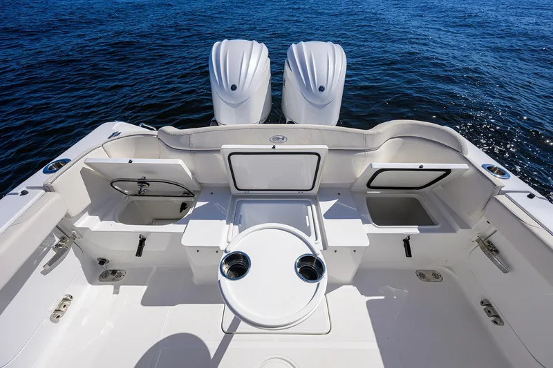 Slide: The Image of 2024 Sea Hunt Ultra 305 SE boat interior with dual engines on open water. - 25