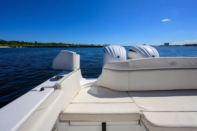 Slide: The Image of 2024 Sea Hunt Ultra 305 SE boat with twin engines on a sunny day. - 26