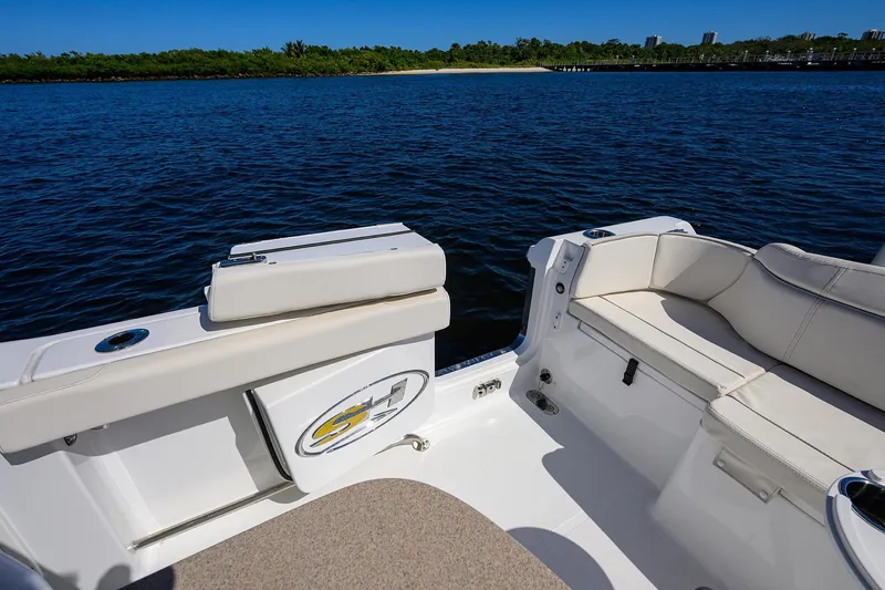Slide: The Image of 2024 Sea Hunt Ultra 305 SE boat interior with cushioned seating and ocean view. - 27