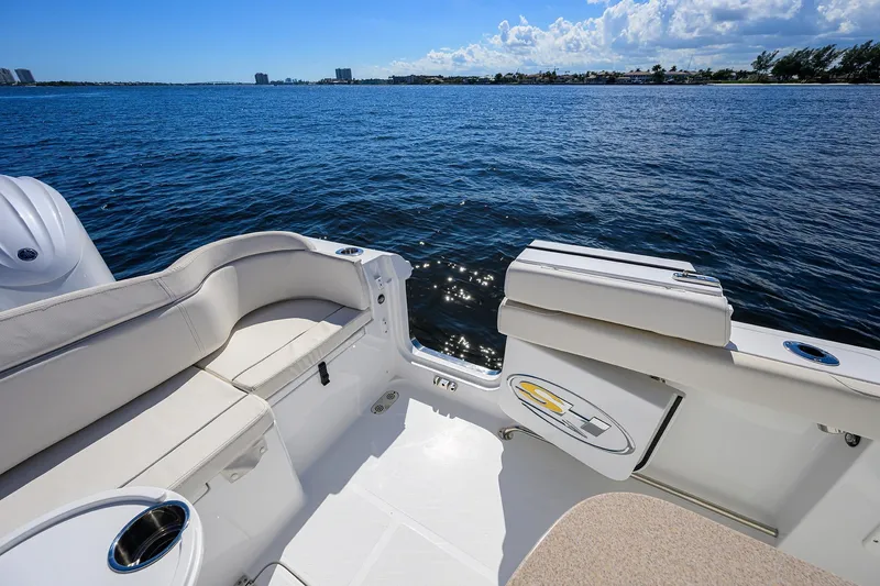 Slide: The Image of 2024 Sea Hunt Ultra 305 SE boat interior with seating, on a sunny day at sea. - 28