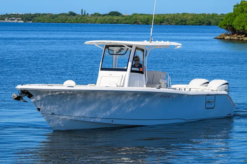 Slide: The Image of 2024 Sea Hunt Ultra 305 SE boat cruising on a calm blue lake. - 3