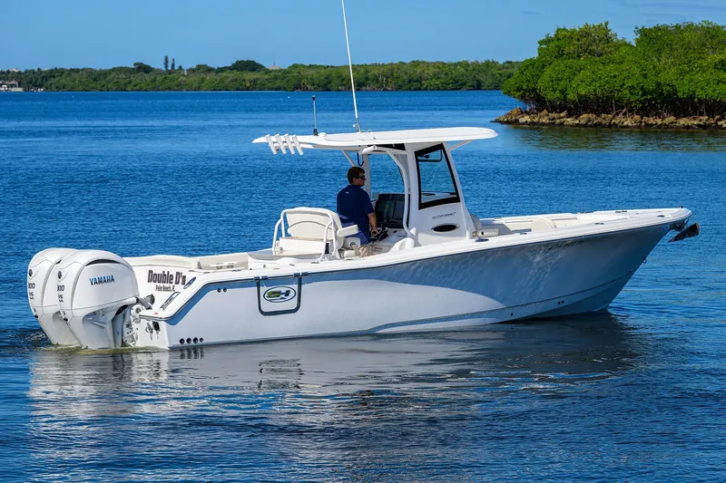 Slide: The Image of 2024 Sea Hunt Ultra 305 SE boat cruising on a calm blue lake. - 7