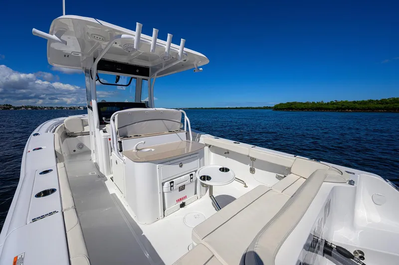 Slide: The Image of 2024 Sea Hunt Ultra 305 SE boat on calm water, featuring spacious seating and modern amenities. - 8