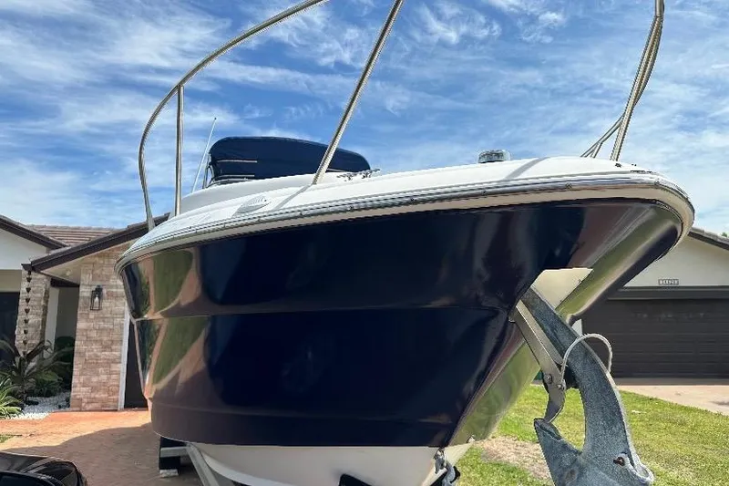 Slide: The Image of 2002 Wellcraft 2600 Martinique boat on trailer, parked in residential driveway. - 1